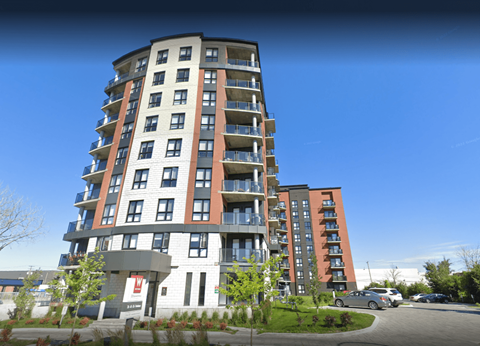 a view of a tall building with a blue sky in the background